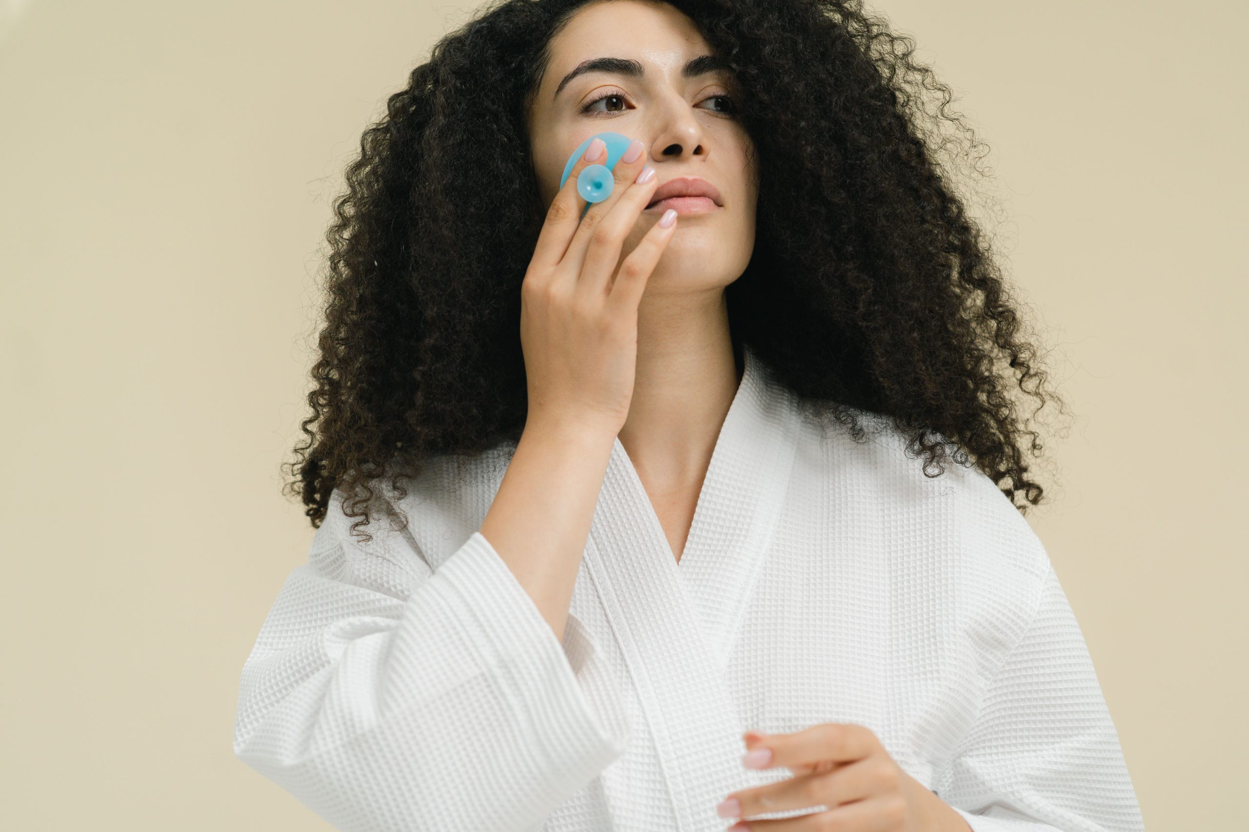 Femme avec rouleau facial relaxation soins