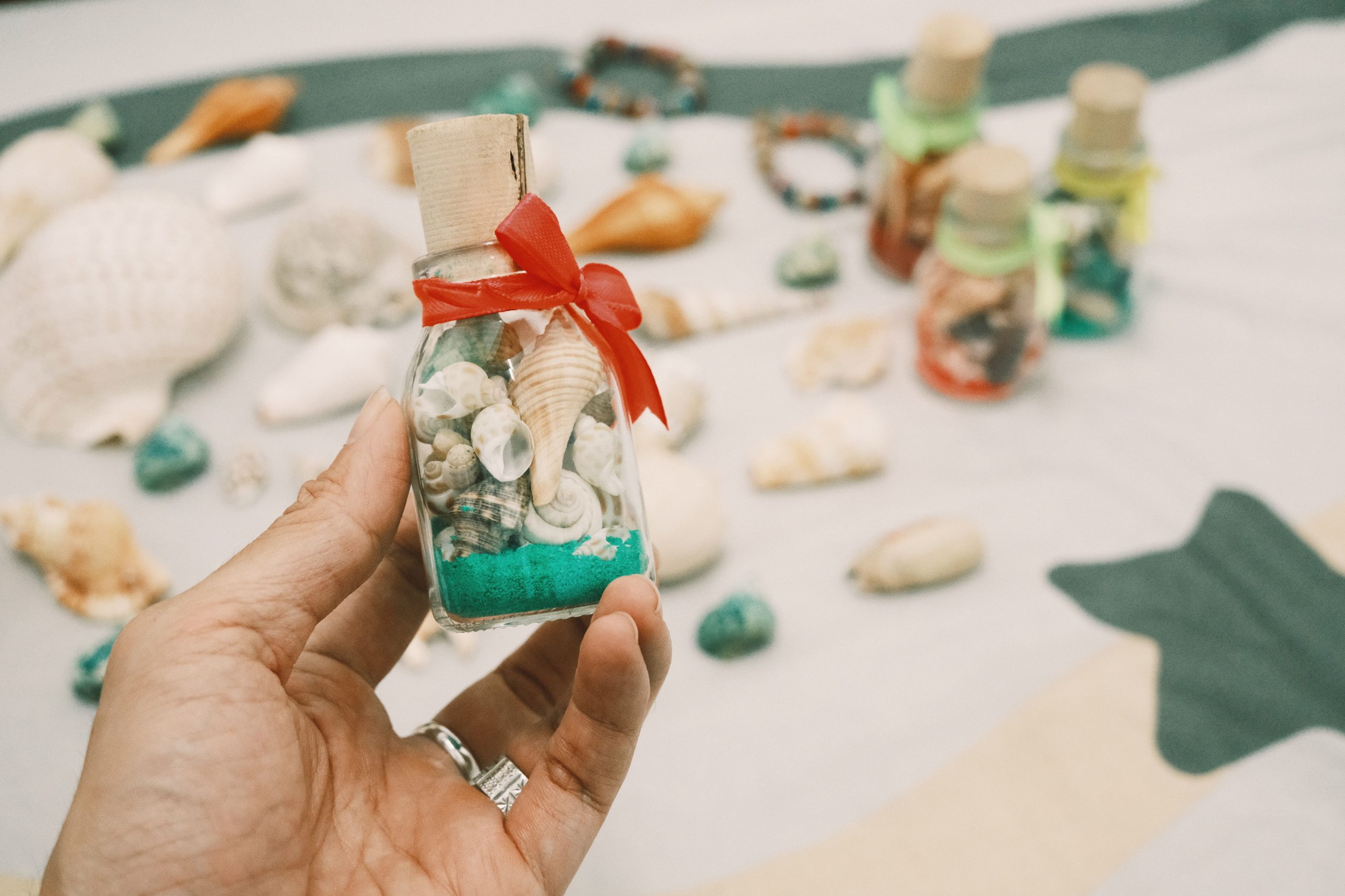 Bouteille décorée remplie de coquillages et sable
